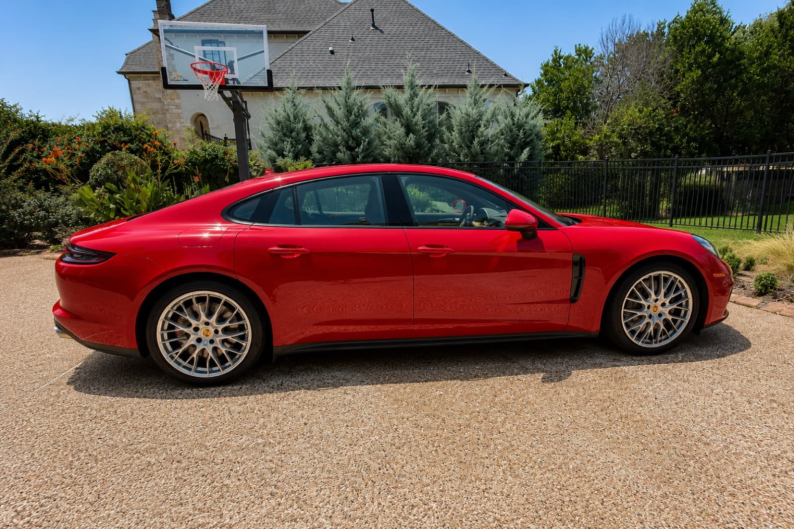 A freshly detailed red Porsche Panamera gleaming after a Cloud 9 detail